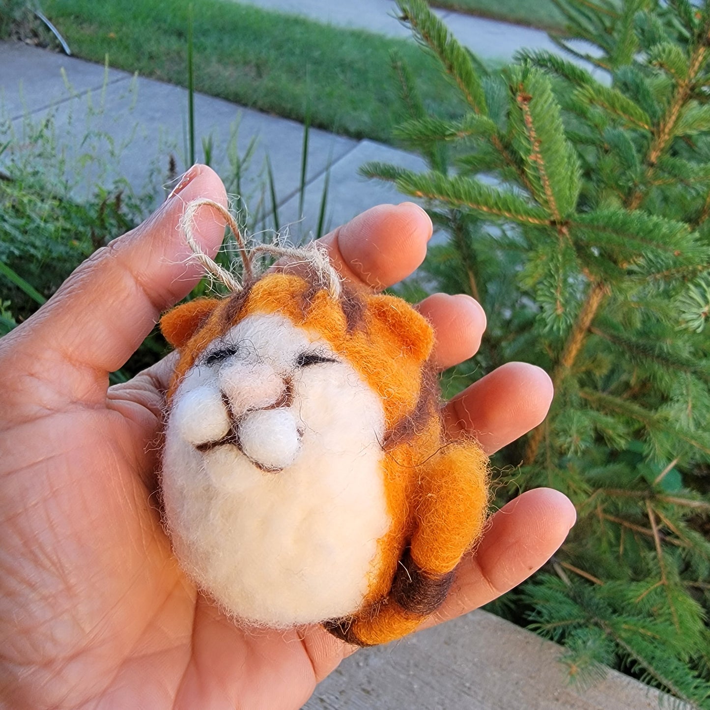 Felt cat ornaments with molded faces.