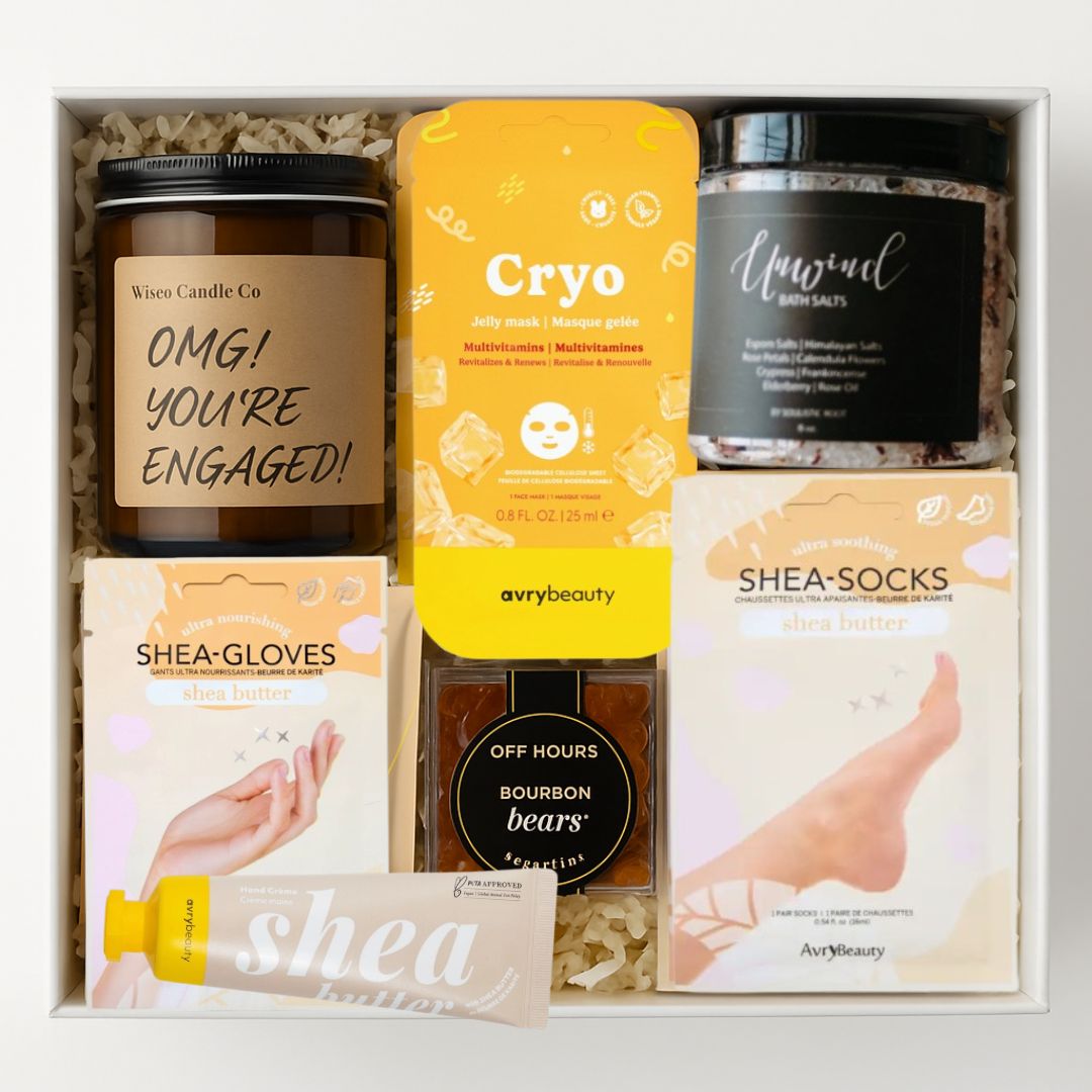 OMG You’re Engaged Gift Box with an engagement candle, bath salts, face mask, shea care essentials, and bourbon gummy bears for the bride-to-be.