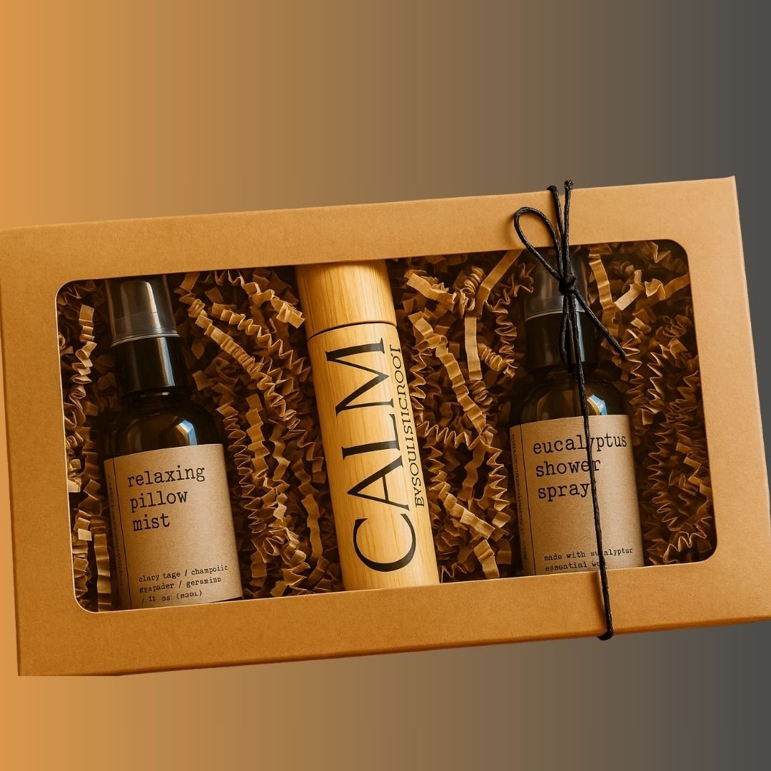 Gift set with 'relaxing pillow mist', 'eucalyptus shower spray', and a cylindrical product in a brown box for wellness gifts