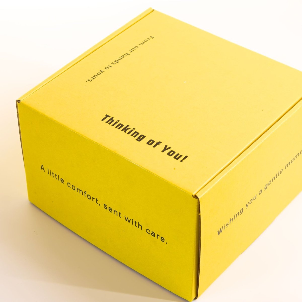 Yellow self-care gift box with coffee mug, herbal tea, bath soak, and chocolate for sympathy, recovery, or everyday encouragement