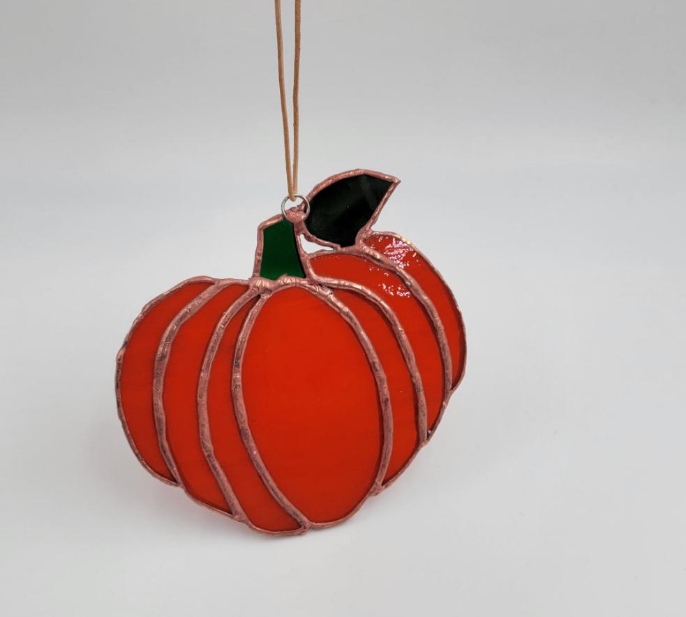 Handmade stained glass pumpkin suncatcher.