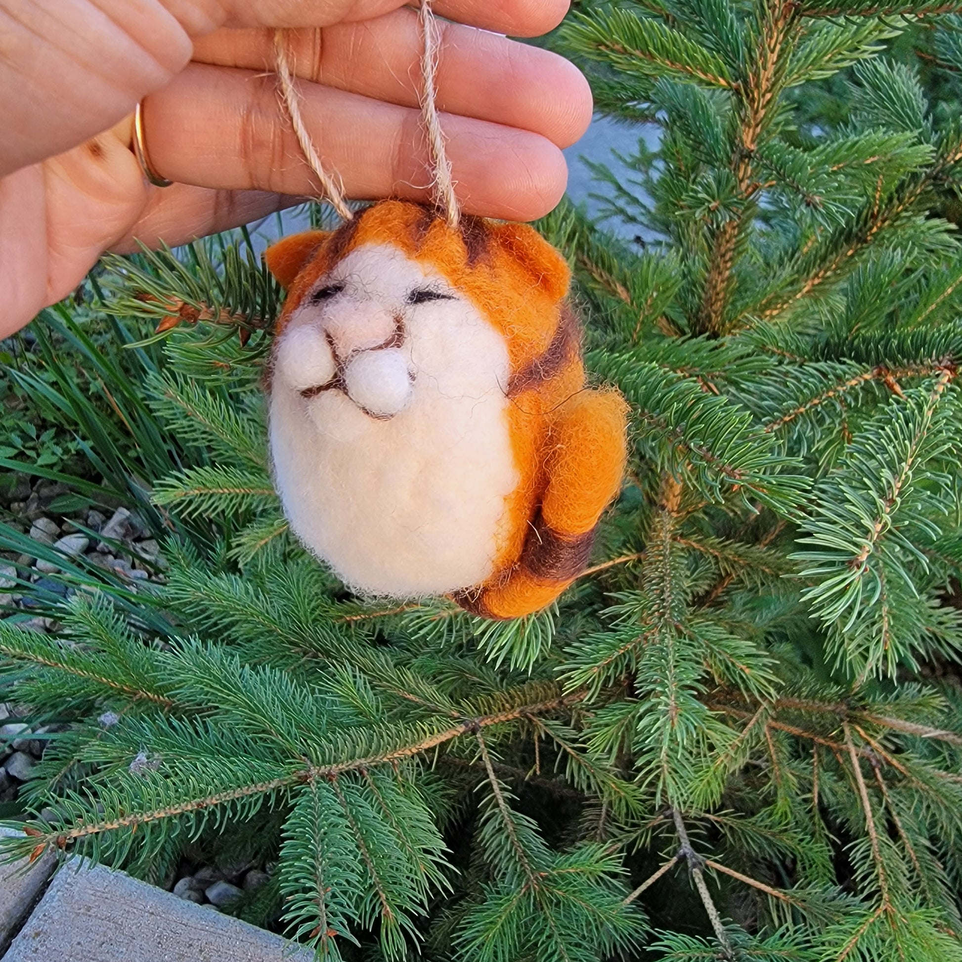Felt cat ornaments with molded faces.