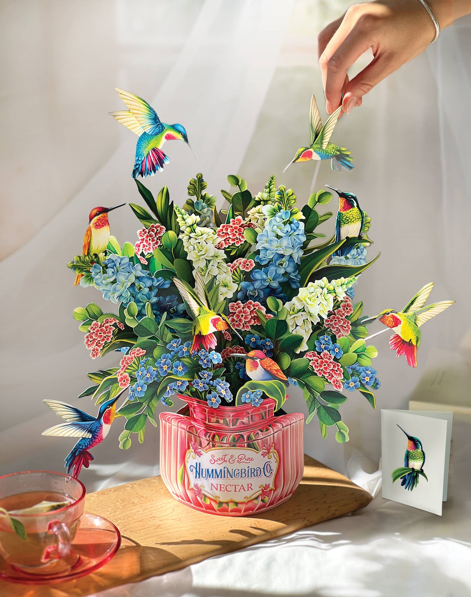 Hummingbird Oasis Pop-up Greeting Card, perfect for curated gift boxes and Build a Box gifting (lifestyle photo)
