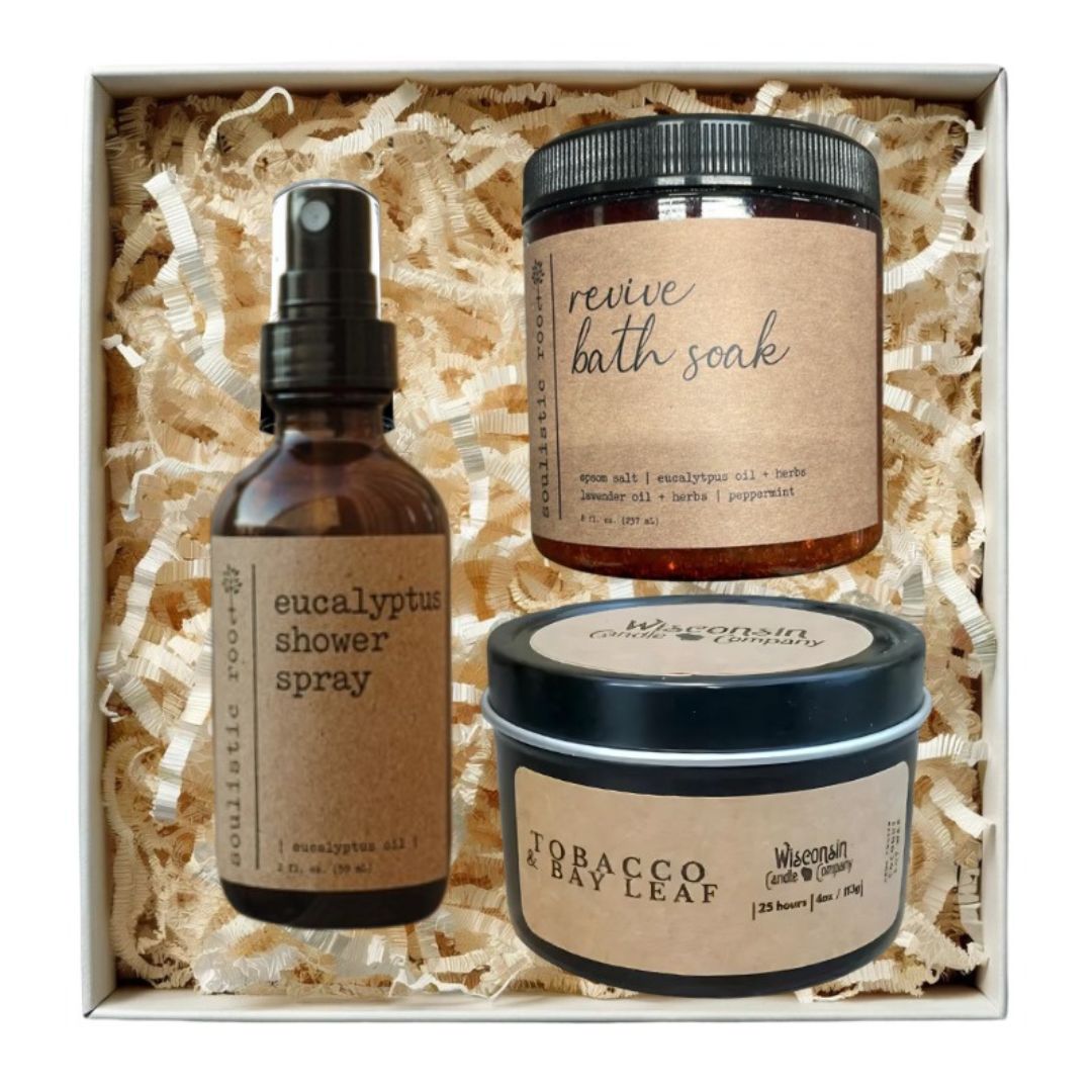 Three natural product items in a box with eucalyptus shower spray, candle, and revive bath soak. Great employee wellness gift
