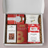  Festive Holiday Treats Gift Box featuring cinnamon hot chocolate, spiced cookies, candied almonds, salted caramel popcorn, and vanilla caramels.
