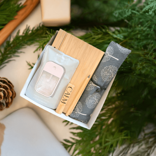 Practical trade show gift box featuring Noshinku hand sanitizer, bamboo office essentials, calm roll-on, and travel cutlery in a white gift box