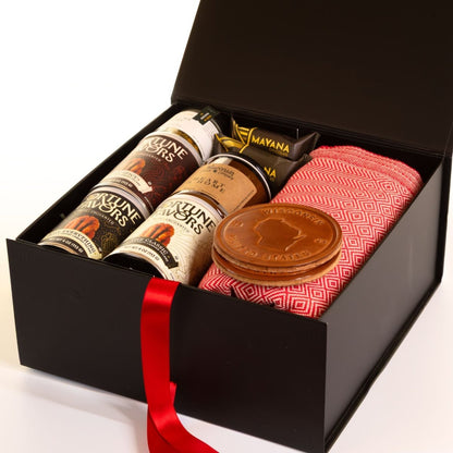 Cozy Wisconsin holiday gift box with blanket, Fortune Favors candied pecans, Mayana chocolates, Wisconsin candle, and leather state coasters