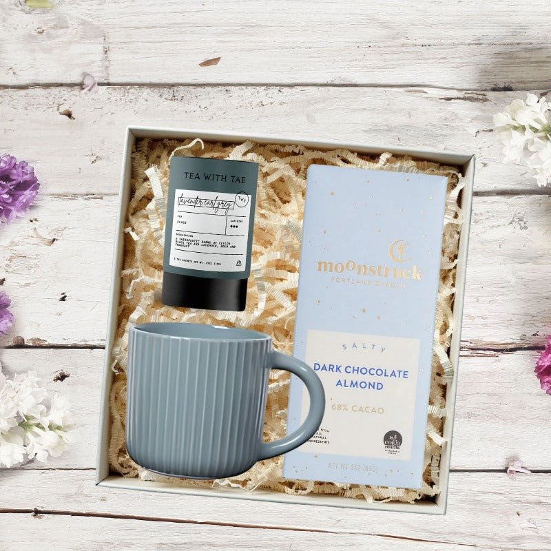 New Employee Onboarding Gift Box with a coffee mug, chocolate, and tea in a mailer box. A polished employee welcome gift for HR teams and new hires.