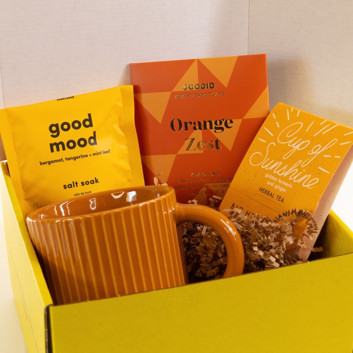 Cheerful get well soon gift box with mug, Cup of Sunshine tea, bath soak, and chocolate packed in a yellow gift mailer