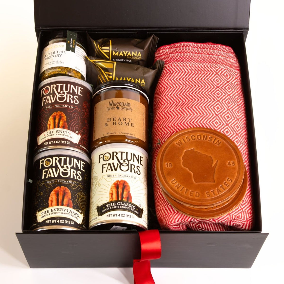 Large Wisconsin comfort gift box with locally made treats, home goods, red blanket, candle, chocolate, and Wisconsin leather coasters