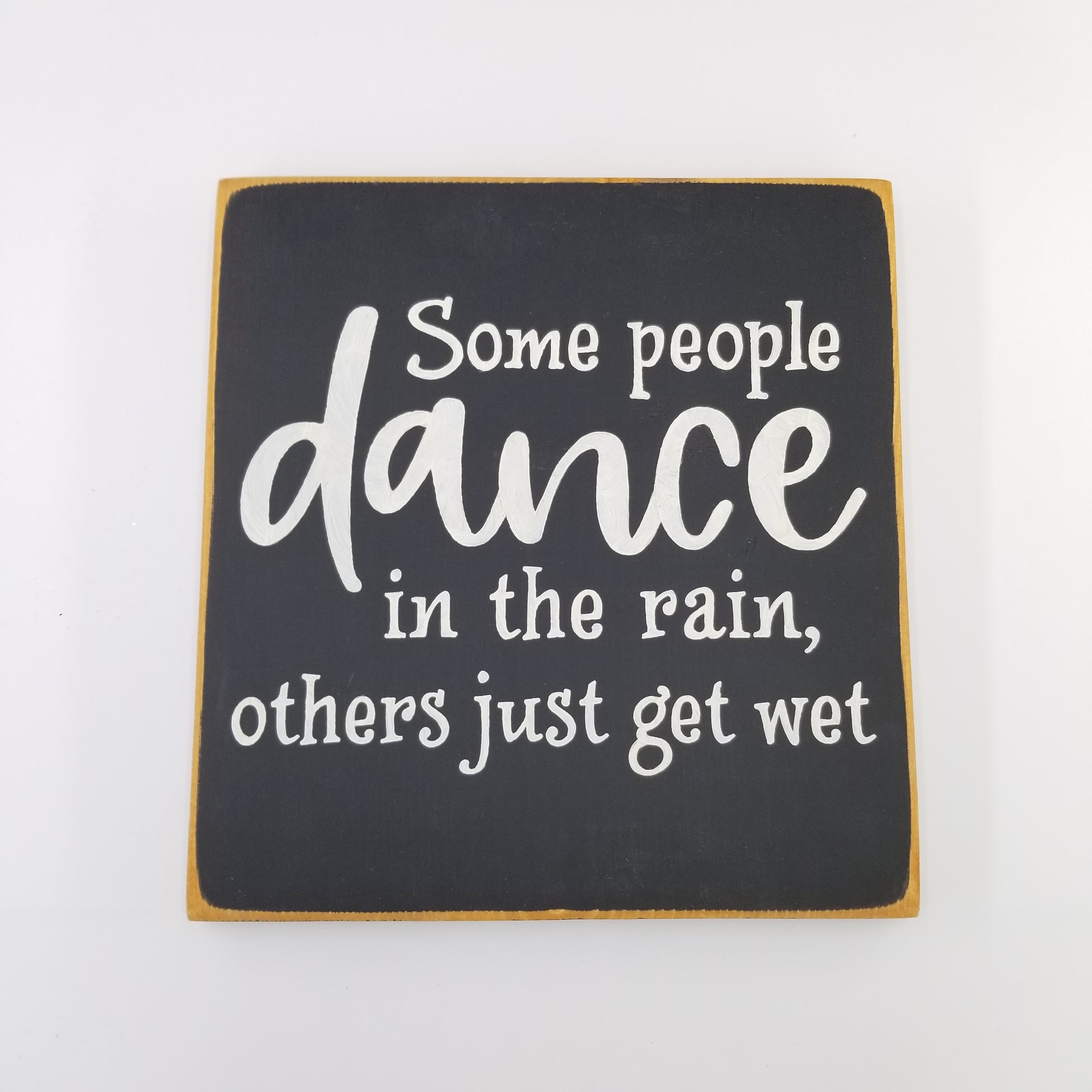 Some people dance in the rain and others just get wet wooden sign
